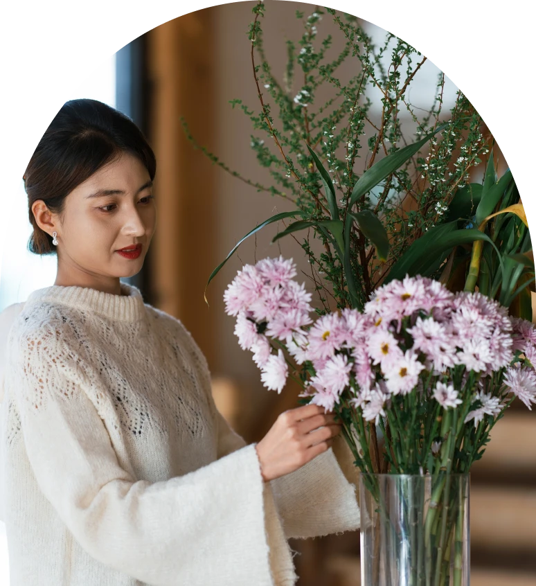 Lady in sweater with flower bouquet